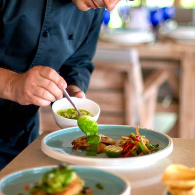a person sitting at a table with a plate of food