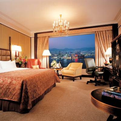 a bedroom with a bed and desk in a room