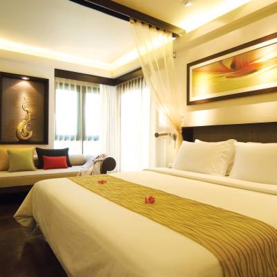 a bedroom with a large bed in a hotel room