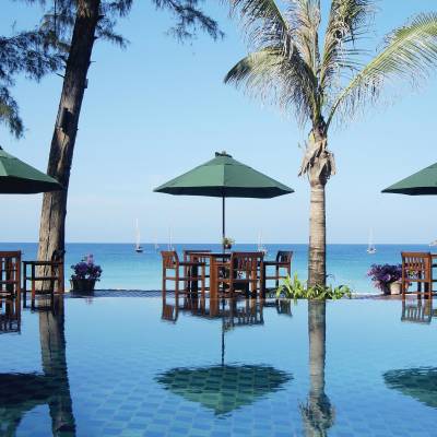a group of lawn chairs sitting on top of a body of water