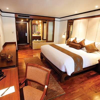 a bedroom with a bed and desk in a room