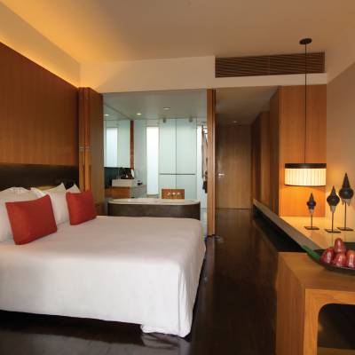 a bedroom with a bed and desk in a room