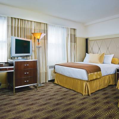 a bedroom with a bed and desk in a room