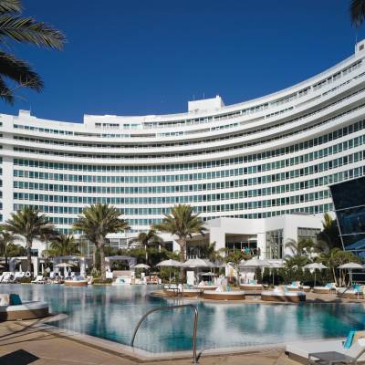 a large pool of water in front of Fontainebleau Miami Beach