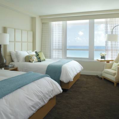 a bedroom with a large bed in a hotel room
