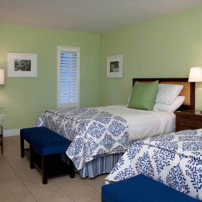 a bedroom with a bed and a chair in a room
