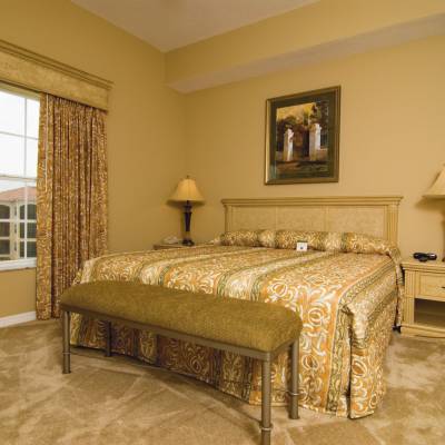 a bedroom with a large bed in a hotel room