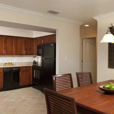 a kitchen with wooden cabinets and a dining room table
