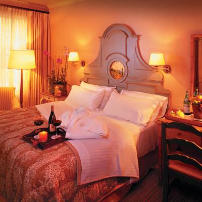 a bedroom with a bed and desk in a room