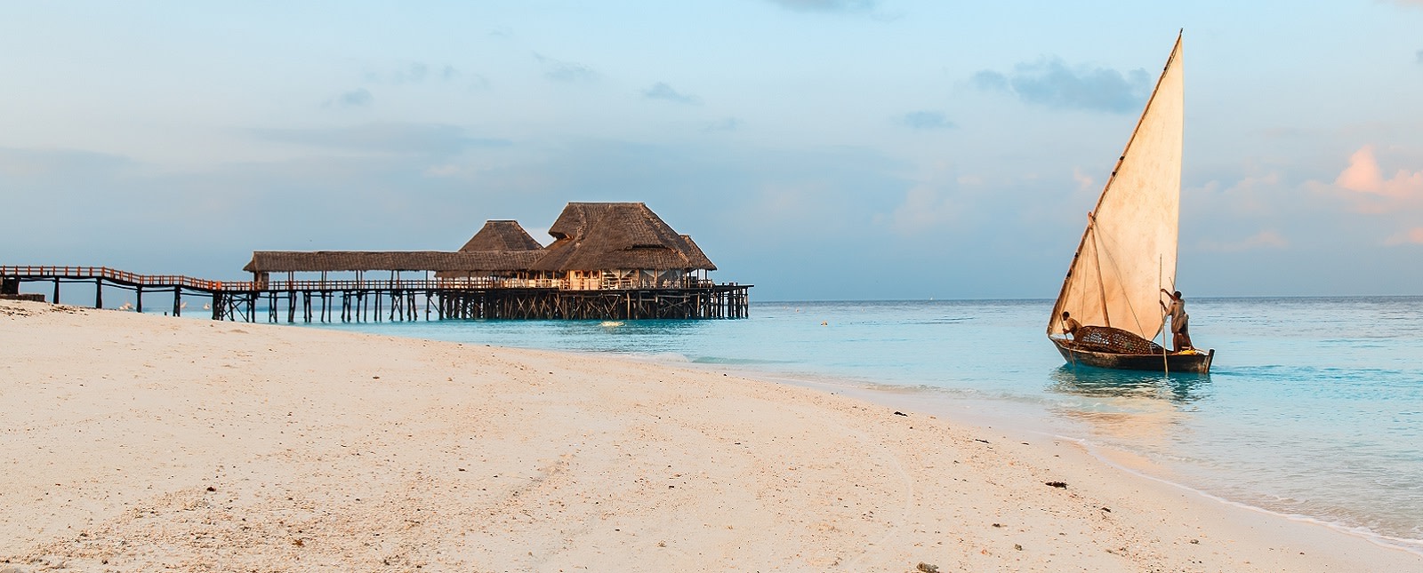 Beautiful sunrise over ocean with fishing boat, fishermen, hut, Nungwi, Kendwa, Zanzibar island, Tanzania Africa Tanzania travel