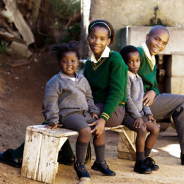 This family of school kids waiting for the bus to their way to school, Africa