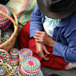 Handmade wicker boxes being sold at a traditional market in Cuenca