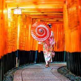Japanese girl in Yukata with red umbrella at Fushimi Inari Shrine in Kyoto, Japan - best time to visit Japan