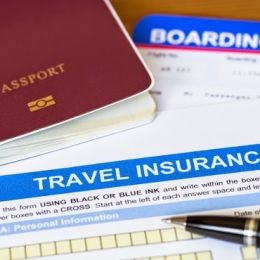 Travel insurance application form with pen and passport
