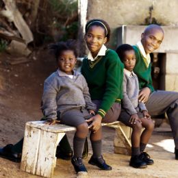 This family of school kids waiting for the bus to their way to school, Africa