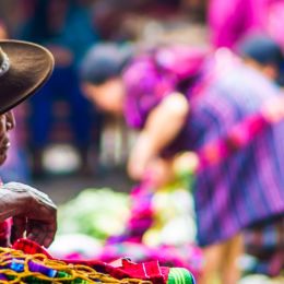 Enchanting Travels Guatemala Tours View on old maya man on market - packing for guatemala - best time to visit Guatemala