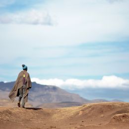 Unidentified Basotho man wearing traditional blanket in the Mountains of Lesotho
