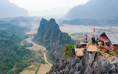 Stunning aerial view of some tourists taking pictures at the beautiful panorama from the Nam Xay viewpoint in Vang Vieng, Laos, Asia