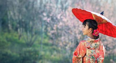 Enchanting Travels - Asian woman wearing traditional japanese kimono, sakura background - private tour of Japan