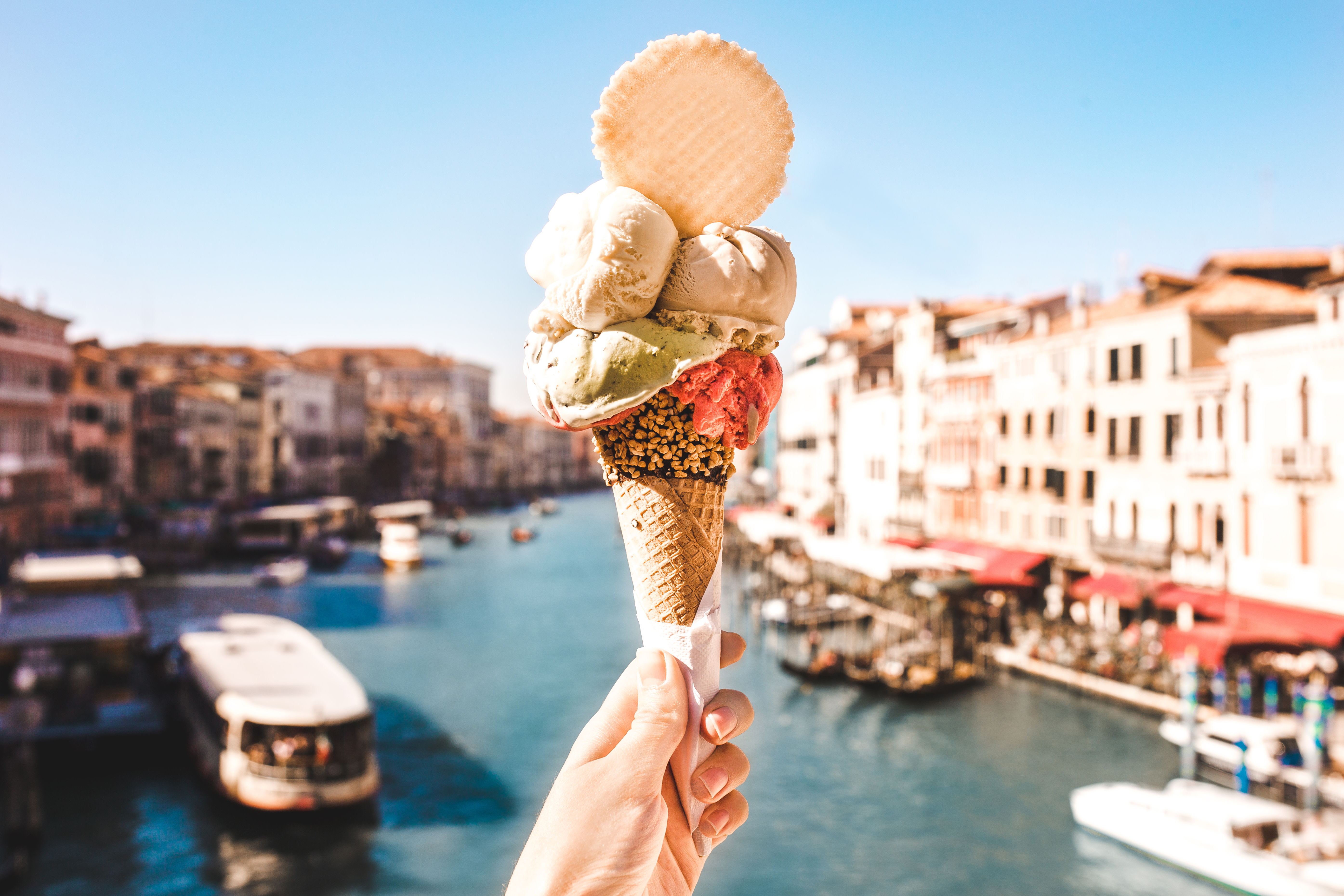 Enchanting Travels Delicious icecream in beautiful Venezia, Italy in front of a canal and historic buildings Enchanting Travels Delicious icecream in beautiful Venezia, Italy in front of a canal and historic buildings