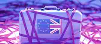 A metal briefcase with overlapping European Union and United Kingdom flags is tightly wrapped in numerous pink ribbons. The briefcase and ribbons are set against a background featuring more scattered pink ribbons in a soft, purple-toned environment.