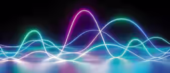 A digital abstract image featuring colorful waveforms of neon light against a black background. The waves, in shades of blue, purple, and pink, appear to overlap and flow, creating a vibrant, dynamic visual effect on a reflective surface.