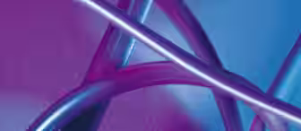 A close-up image of several metallic tubes intertwined against a gradient background of pink and blue hues. The tubes reflect the colors, creating a visually abstract and vibrant composition.