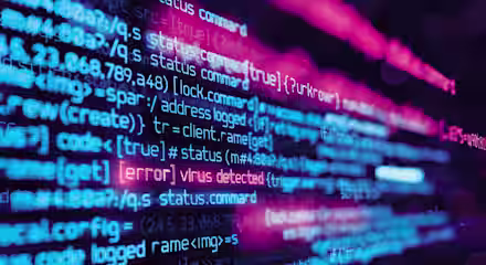 A close-up of computer code displayed on a screen, with lines of code in vibrant blue, pink, and purple colors. One line of text is highlighted in red, stating "[error] virus detected," indicating a security issue within the code.