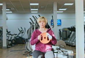 Female member working out in the gym with a weight in her hand