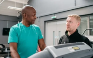 Man on the treadmill with a staff member