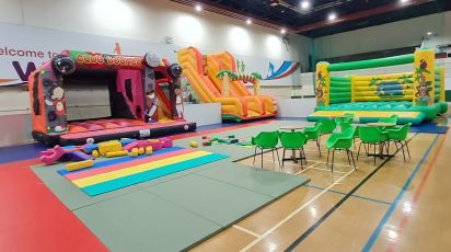 An image of two inflatables and the large slide as well as the soft play area
