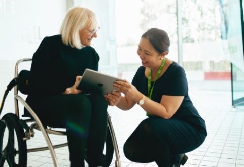 staff member showing customer how to book