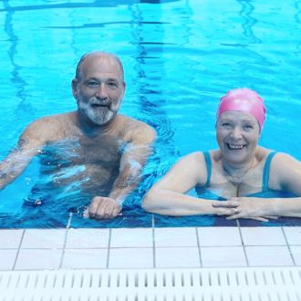 Two seniors swimming together in the pool at Hatfield Swim Centre