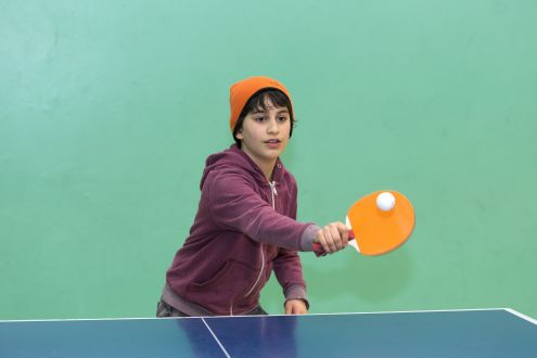 An image of a teenager playing table tennis