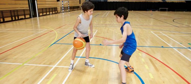 2 Children playing with a Basketball