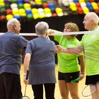 Badminton players playing at Southbury Leisure Centre in the sports hall