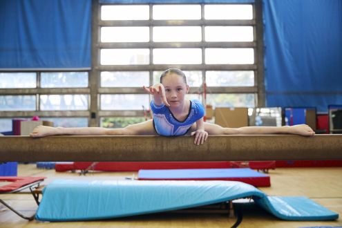 A young gymnnast on the bar