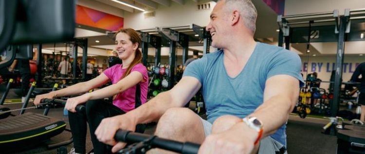 adult and junior on rowers together