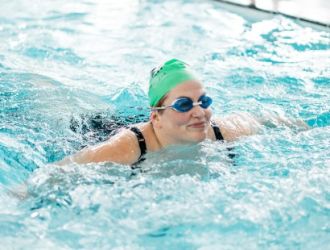 lady swimming with swim cap on