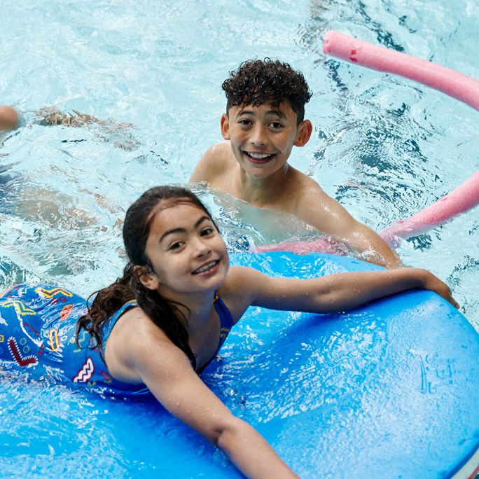 kids enjoying playing with pool floats and swimming for a quid