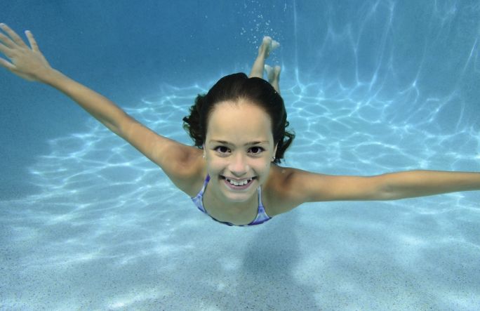 child being taught how to swim