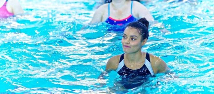lady in a pool aqua workout class 