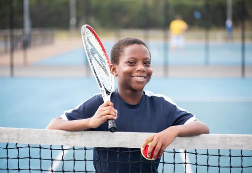 boy playing tennis