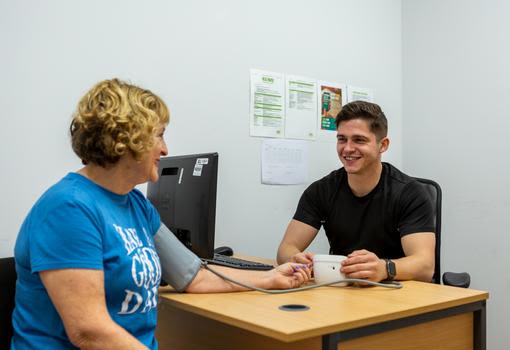Health check within the gym with a fitness instructor