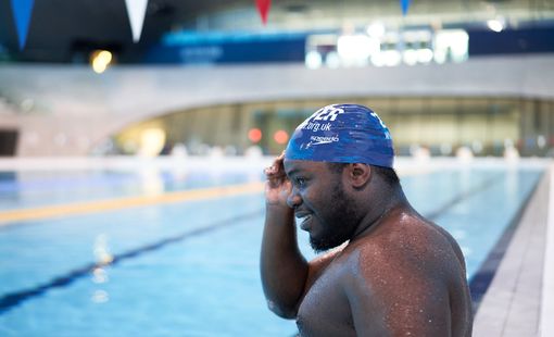 Male swimmer with blue swim cap