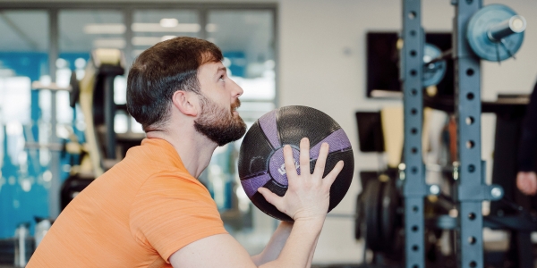 Man doing wall balls Man doing wall balls
