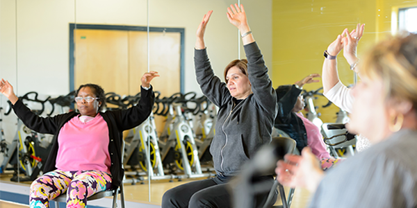 People doing a Seated Yoga class in chairs