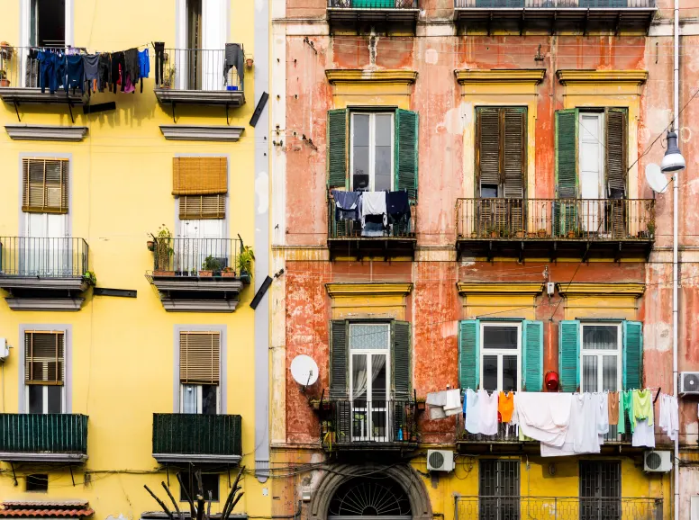 Front View of Apartment Buildings in Naples with Clothes Hanging From Balconies