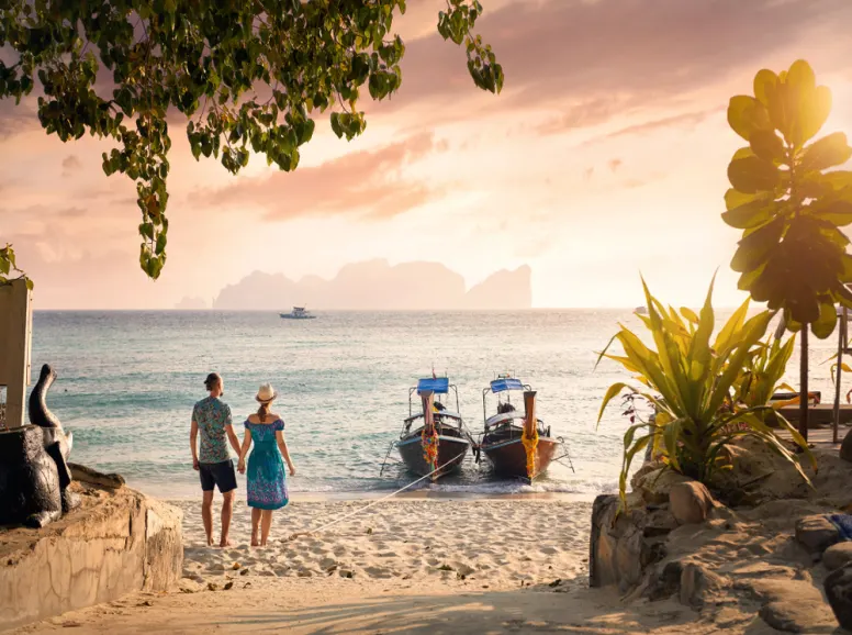 Two People Walk towards the Sunset on Phi Phi Island Phuket