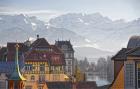 Colorful Historic Buildings with Snowy Mountain Backdrop over Lake Thun
